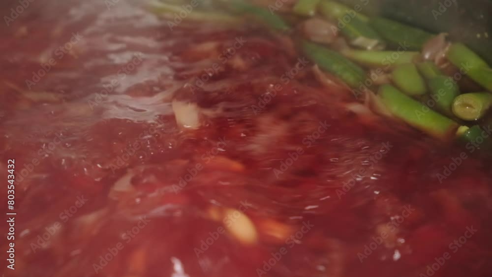 Boiling soup Healthy red vegetable tomato soup food in bowl in kitchen. Cuisine National traditional food Boiling soup Healthy red vegetable tomato soup food in bowl in kitchen. Cuisine National traditional food