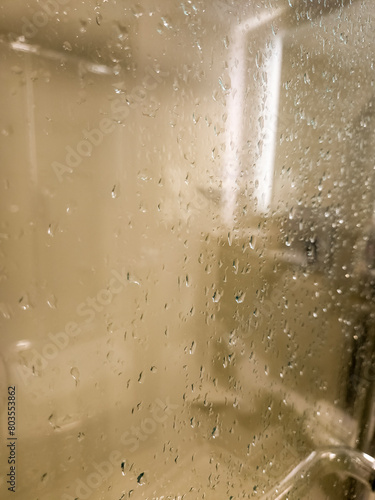 Wet shower stall glass with steam and water drops
