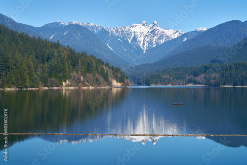Capilano Lake Lions Peaks Reflection North Vancouver. The view of the Lions high over the Capilano Lake Reservoir in Capilano River Regional Park, North Vancouver, British Columbia.   © maxdigi