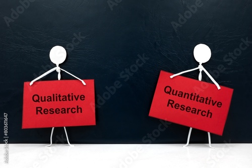 Quantitative vs qualitative research concept. Human stick figure holding red placard paper with written text. photo