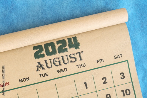 August 2024 calendar flat lay in blue background with copy space.