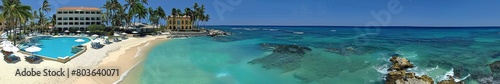 Panoramic View of a Tropical Beach Resort with Crystal Clear Waters and Lush Palms, Perfect for a Luxurious Getawa © Ross