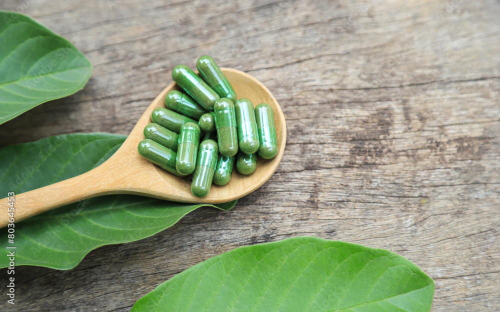Green herbal capsules from herb for healthy eating in daily life Green herbal capsules from herb for healthy eating in daily life
