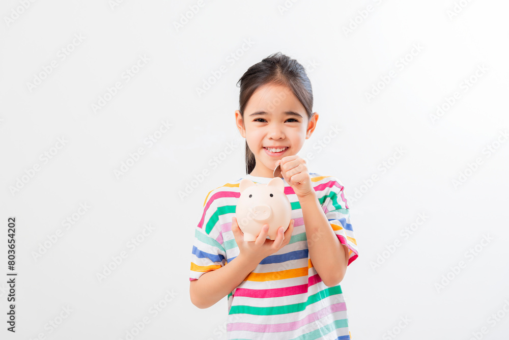 Little Asian girl saving money in a piggy bank, learning about saving, Little Asian girl saving money in a piggy bank, learning about saving,