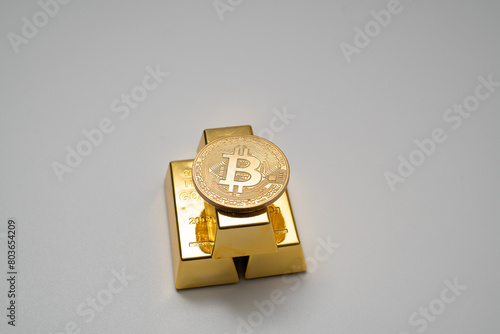 Bitcoin and gold bar on white background
