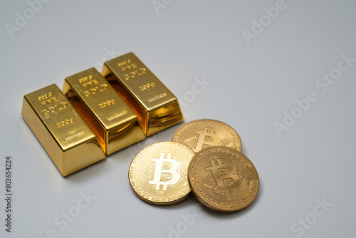 Bitcoin and gold bar on white background