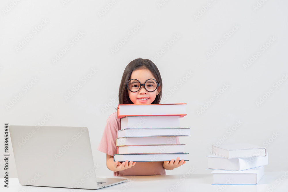 a student on the table and laptop among a large number of books a student on the table and laptop among a large number of books