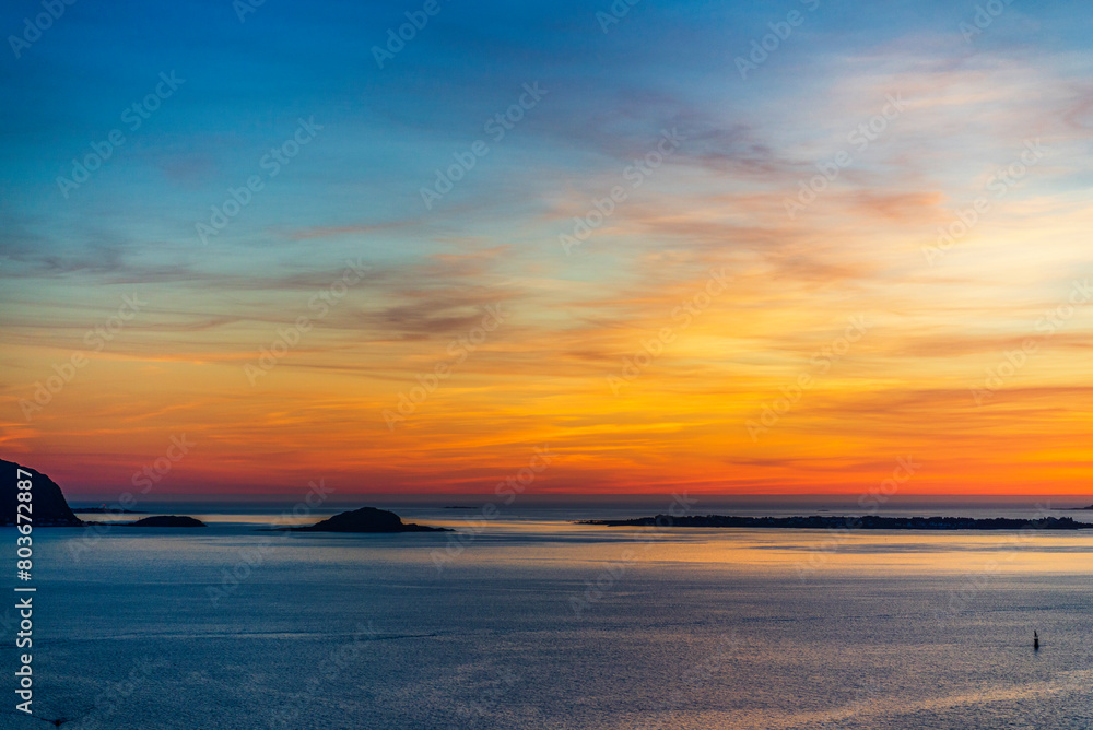 Obraz premium top view of a sunset over The city of Alesund and the sea during a sunny evening, Norway