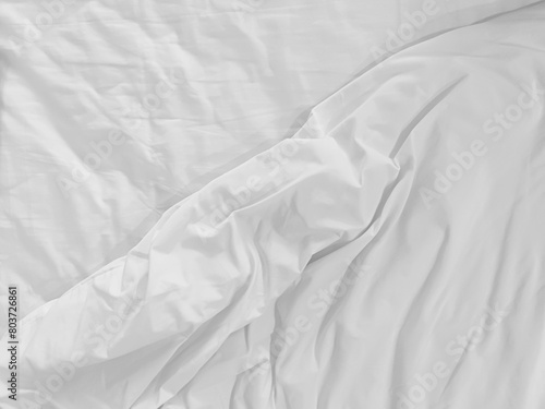 Unmade bedding sheets top view background. White wrinkled blanket after sleeping. Messy duvet. Cozy fabric surface. Untidy bedspread backdrop.