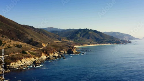4K drone footage of mountain nature along the Western Pacific Coast in Monterey. Colorful scenery on the way to San Francisco. Blue ocean view in sunny day. Big Sur National Park, California. USA