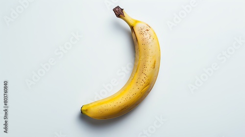 Highresolution image of a single banana lying horizontally, captured on a pure white background, emphasizing clarity and simplicity, perfect for healthfocused content photo