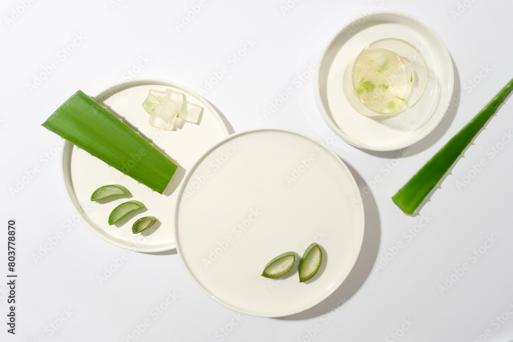 Top view photo with blank round dish placed in center for displaying products which made from aloe vera. Blank space for designing or advertising Top view photo with blank round dish placed in center for displaying products which made from aloe vera. Blank space for designing or advertising