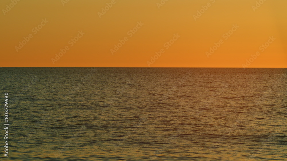 Obraz premium Ocean At Sunset. Right Burning Sunset Above Sea. Sun Is Setting Over Sea Or Ocean. Slow motion.