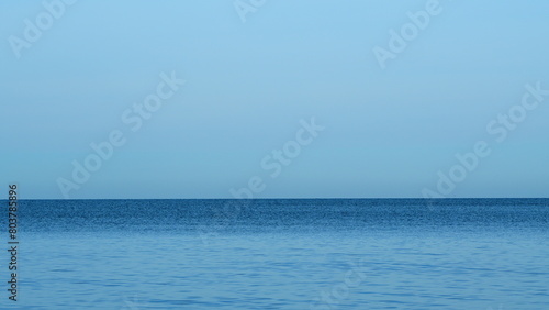 Blue Sky And Small Smooth Waves. Dramatic Landscape Clouds Above The Sea Or Ocean. Real time.