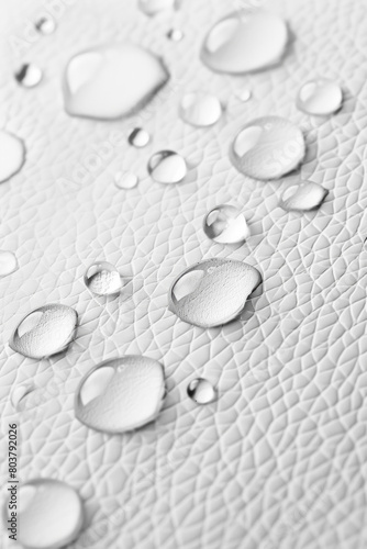 Water droplets on white leather, texture pattern for background 