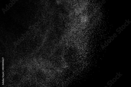 Black and white grunge texture background. Abstract splashes of water on dark backdrop. Light clouds overlay. 