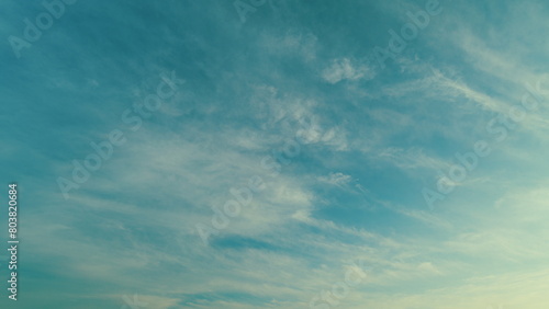 Beautiful cirrus clouds visible in blue sky. Translucent cirrus spindrift clouds high up. photo