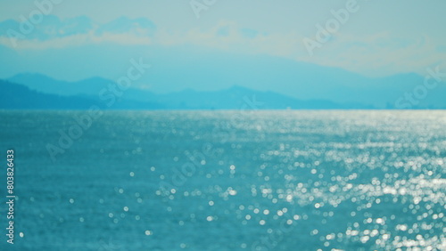 Abstract And Background Concept. Small Waves On Water Surface In Motion Blur With Bokeh Lights.