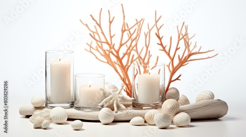 Contemporary styled image of a chic beachthemed centerpiece with coral pieces and candles displayed against a solid white background suitable for a beach wedding or coastal event decor photo