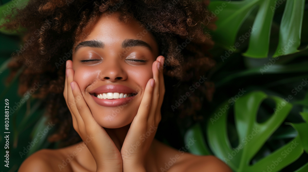 A woman with her hands on the sides of her face smiling, Concept of relaxation, as the woman is enjoying her time in natural environment. A woman and monstera a commercial shoot for a skincare brand A woman with her hands on the sides of her face smiling, Concept of relaxation, as the woman is enjoying her time in natural environment. A woman and monstera a commercial shoot for a skincare brand