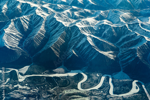 aerial view of snow capped mountain and winding frozen river © nd700