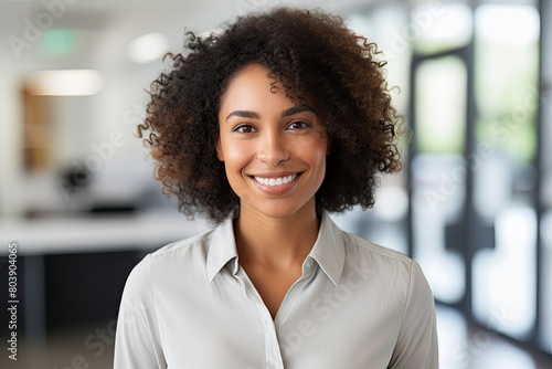 smiling woman with curly hair in office
