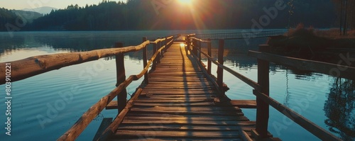 View of the wooden bridge on the lake at sunrise in the morning #803910221