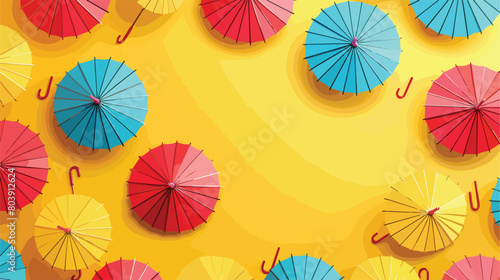 Different mini umbrellas on yellow background 
