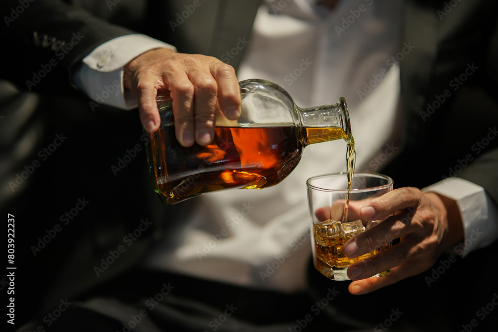 Closeup businessmen holding a glass of whiskey Closeup businessmen holding a glass of whiskey