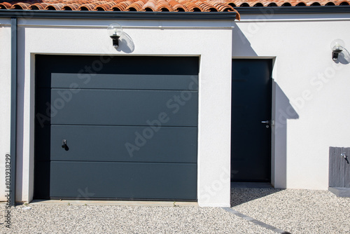 door gray modern on facade white closed new garage home gate at entrance of private house © OceanProd