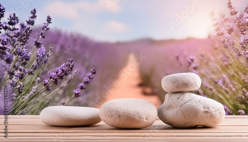 microphone on a wooden table  soap and towel  lavender flowers in a bottle  lavender on the beach  Stones and lavenders on wooden desk on background of lavender field. Spa still life in pastel colors