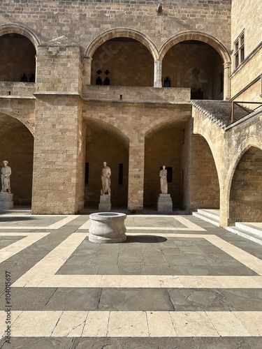 Old Greek marble statues and fountain in the courtyard of the palace of the grand master of the knights of Rhodes in medieval city of Rhodes  Greece