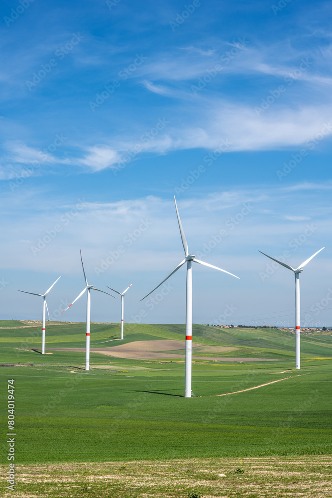 Wind turbines and green agricultural landscape seen in Puglia, Italy Wind turbines and green agricultural landscape seen in Puglia, Italy