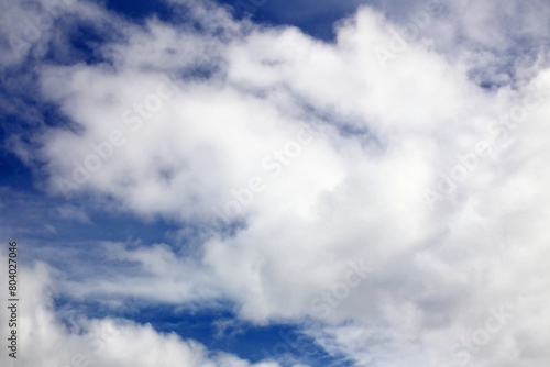 Cumulus clouds background with vibrant blue sky