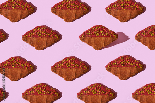 pattern of flat croissant on pink background