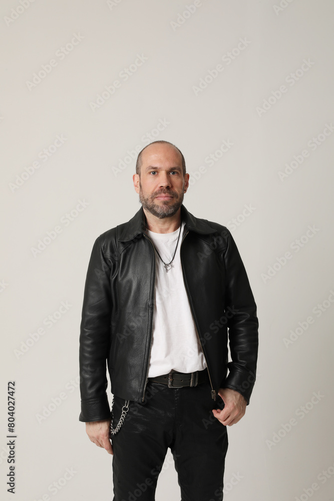 Fototapeta premium Vertical portrait of mature man looking at the camera posing indoor. Isolated.