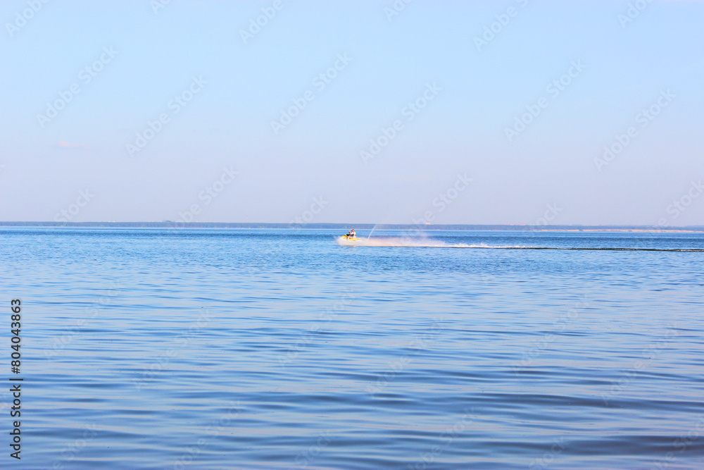 Blue sea and blue sky, beautiful waves. View from the beach to the rocky bay Morning light over the sea in Sanremo,