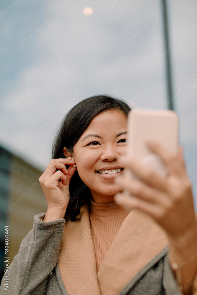 Happy businesswoman using smart phone for video call Happy businesswoman using smart phone for video call