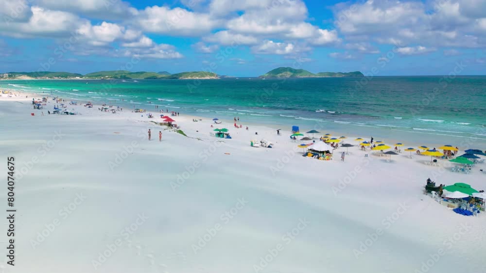 Varadero Beach in Cuba with tourists relaxing on its white sandy shore with azure sea and green islands. Aerial drone view.