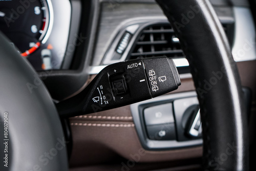 Switch off lights in a car. close-up Car integrated turning indicator with headlight switch toggle. © Muanpare