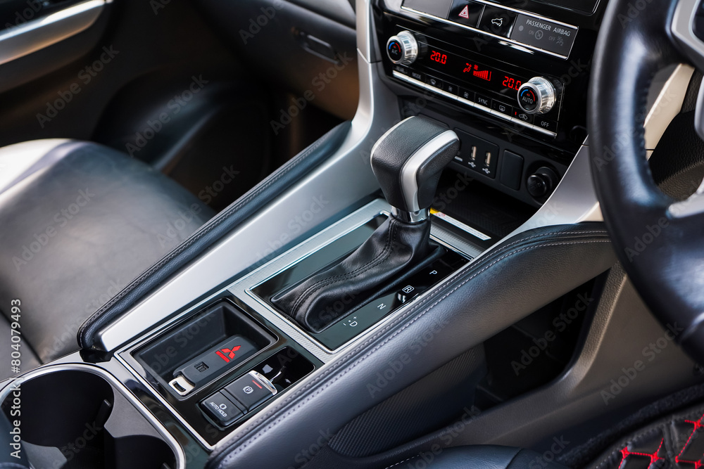 Fototapeta premium automatic transmission shift selector in the car interior. Closeup a manual shift of modern car gear shifter. 4x4 gear shift 