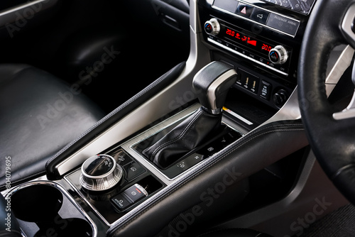 automatic transmission shift selector in the car interior. Closeup a manual shift of modern car gear shifter. 4x4 gear shift  © Muanpare