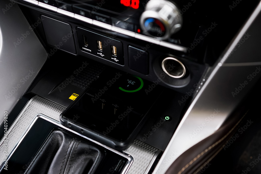 Wireless mobile charger in the modern car. Portable wireless car charger for smartphone. Wireless mobile charger in the modern car. Portable wireless car charger for smartphone.