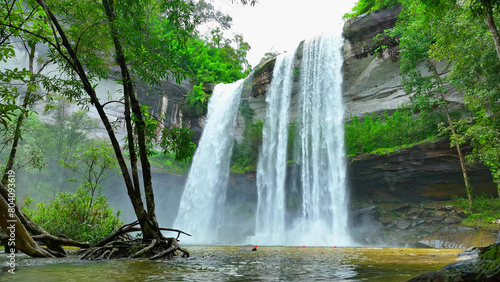 A breathtaking tropical waterfall cascading from a towering cliff  an epic natural wonder. Huai Luang Waterfall  Phu Chong Na Yoi national park  Ubon Ratchathani Province  Thailand. Nature concept. 