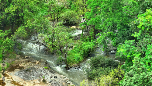 Tropical majesty: A grand waterfall, harmoniously merging with a lush, green wilderness, creates a breathtaking spectacle of nature's splendor. Roam earth's wonders concept. Thailand.
