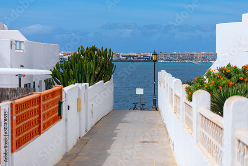 White architecture in village on the ocean shore, Corralejo, Fuerteventura Canary islands. Way to the ocean photo