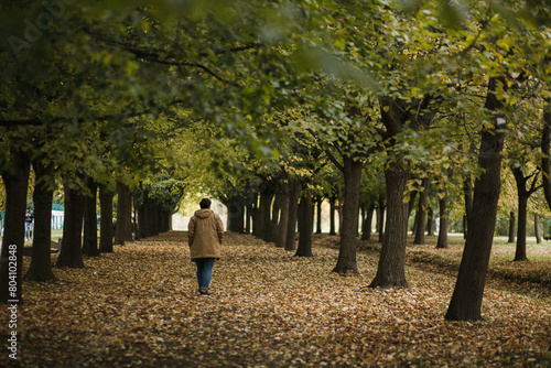 man walking alone in a green park