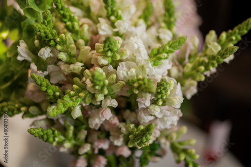 bouquets of flowers are on the table, a tray with a cup and a glass of water