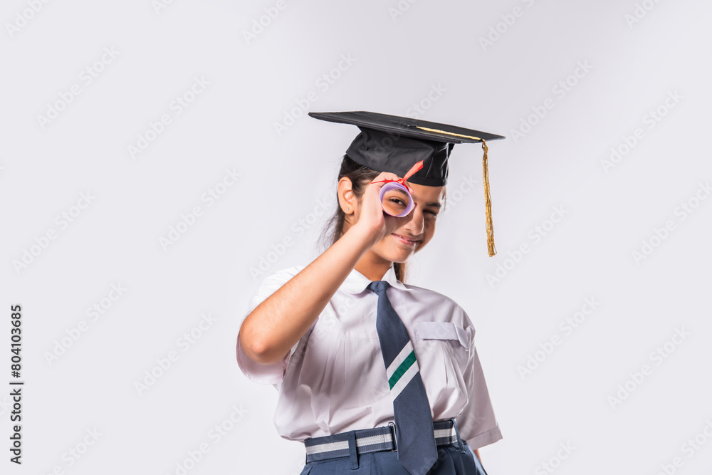 Indian asian cute little school girl wesra graduation white against white background Indian asian cute little school girl wesra graduation white against white background