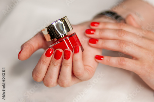 manicure on a white background and red nail polish